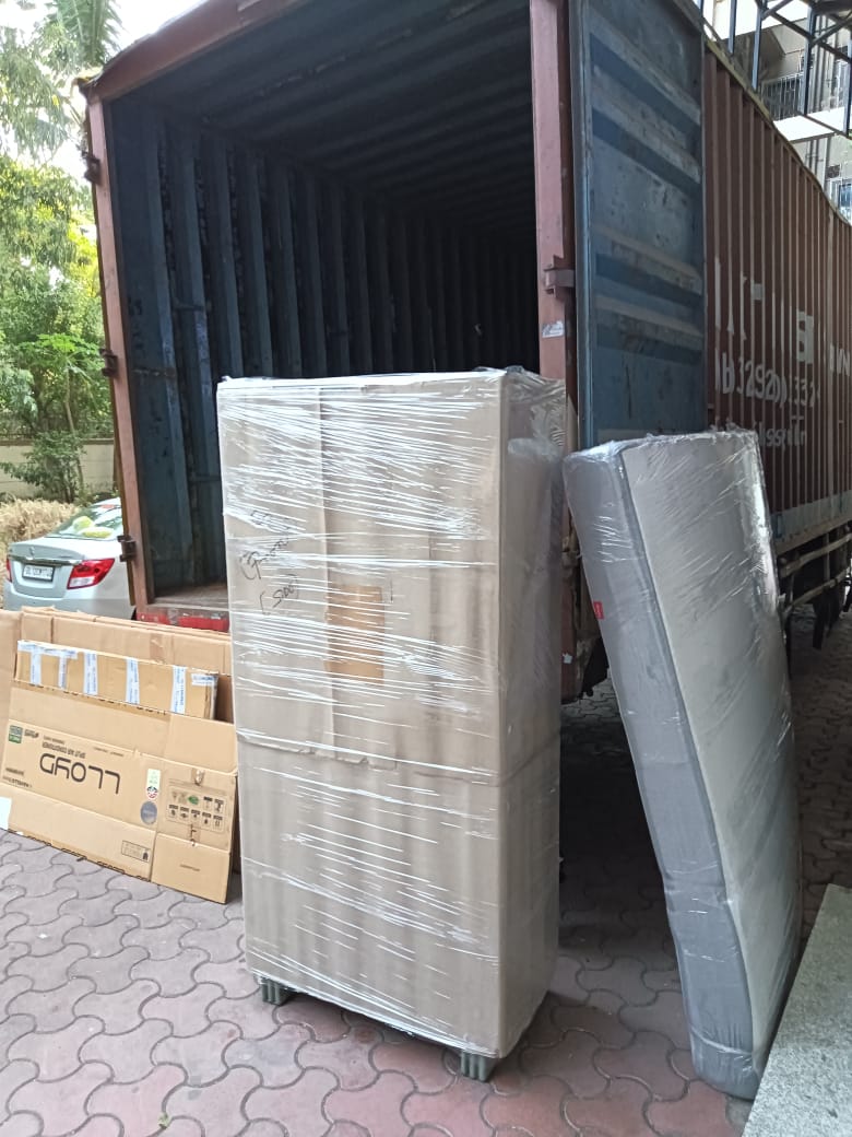 Team loading cartons into a covered truck